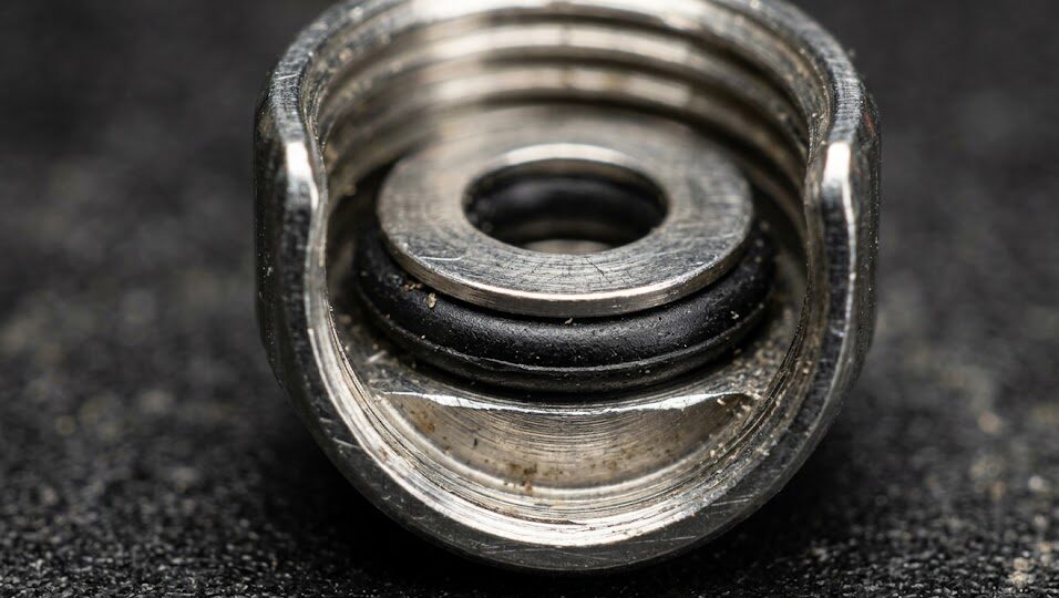 Macro view of a captive crown gasket trapped inside the Seiko 6105 retaining washer mechanism