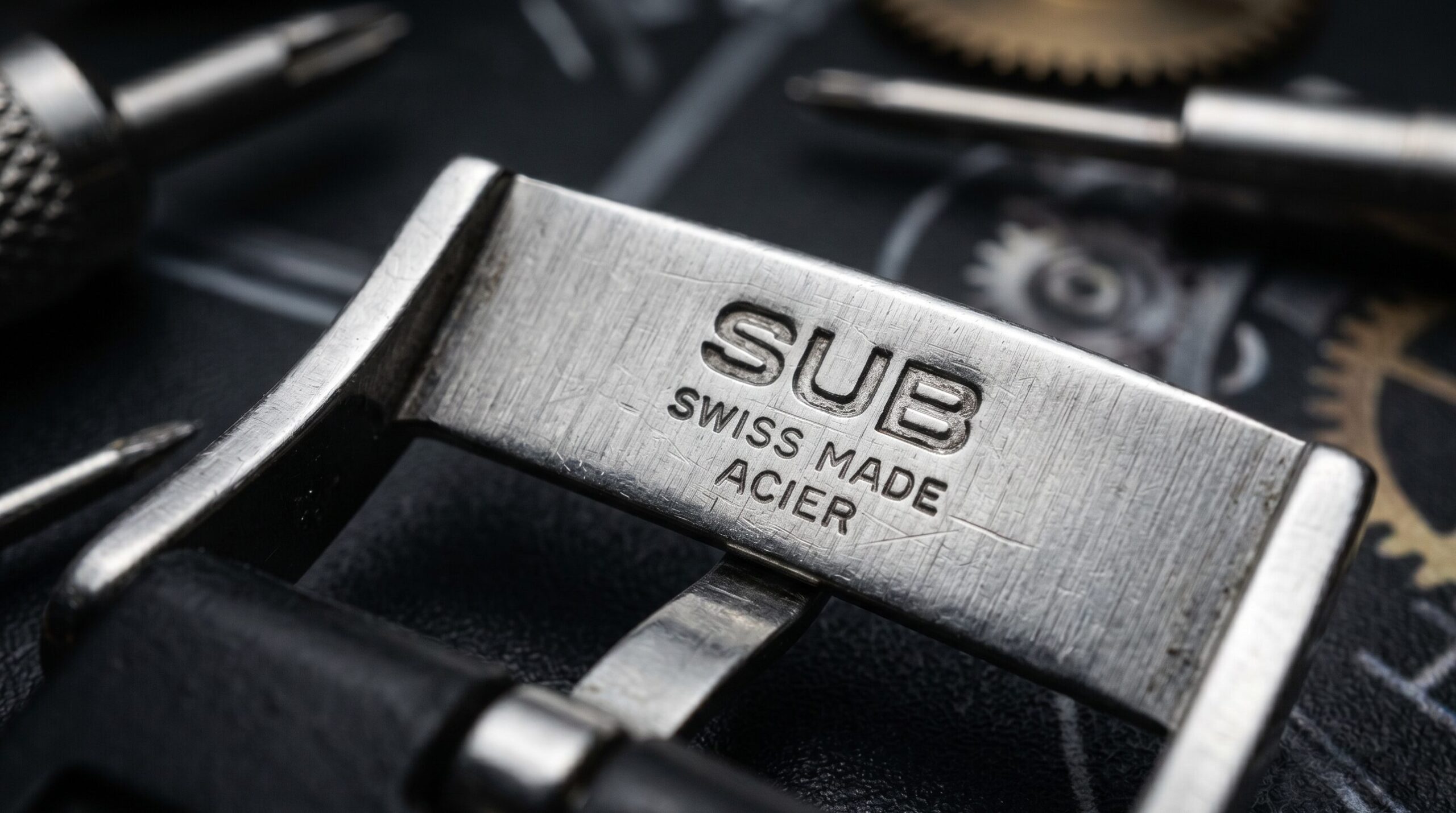 Authentic Swiss Tropic vintage watch straps highlighting the stamped SUB logo on the steel buckle